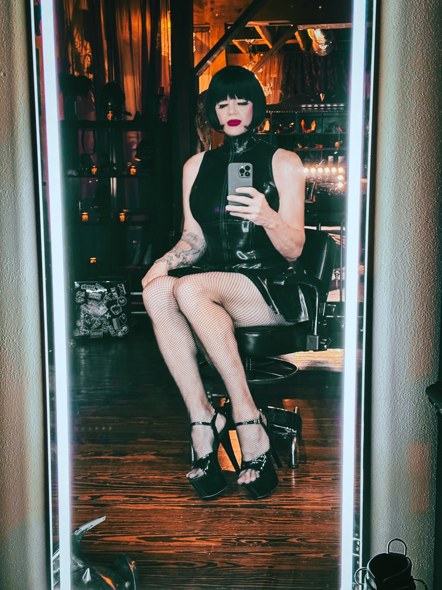 TS Mistress Mia in a dungeon mirror